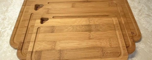 3 bamboo cutting boards stacked on a counter