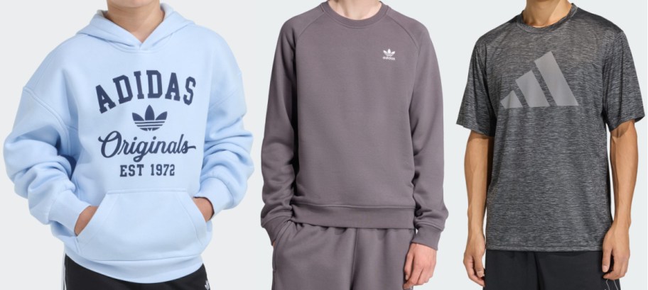 Three different Adidas clothing items shown side by side: a light blue hoodie with "Adidas Originals EST 1972" text, a grey crewneck sweatshirt and matching sweatpants set with a small logo, and a dark grey heathered athletic t-shirt with a large logo paired with black shorts.