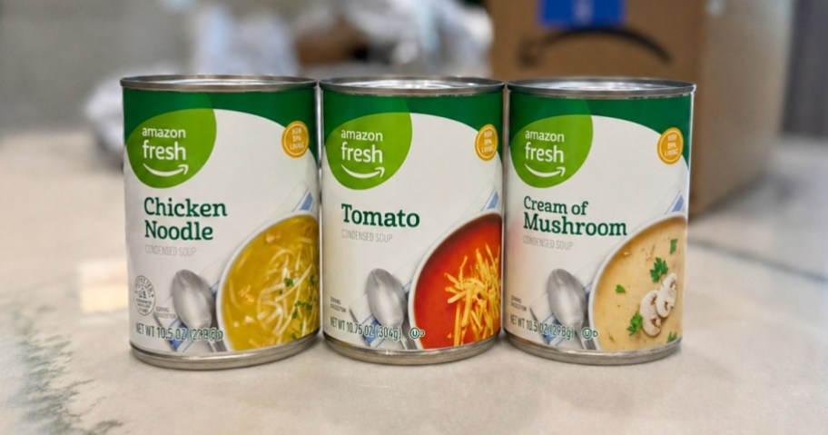 three cans of Amazon Grocery soup on a kitchen counter