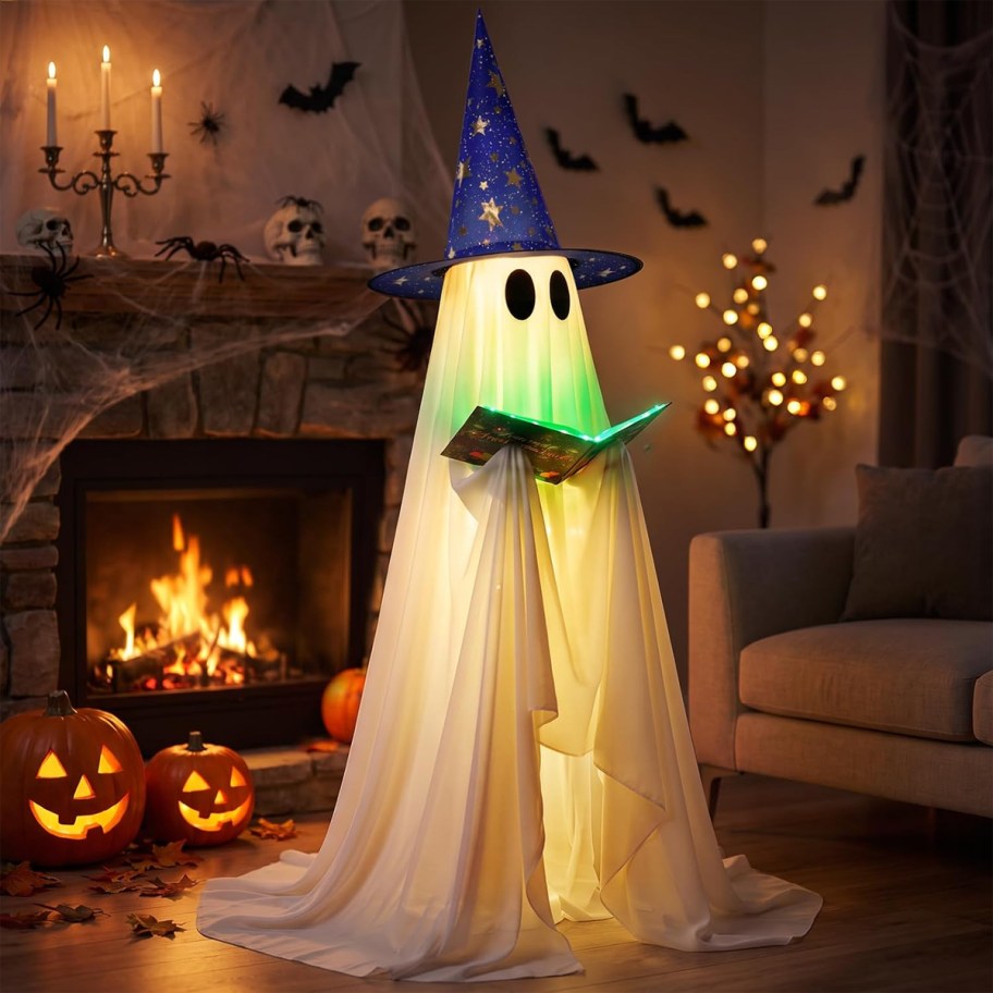 ghost wearing purple witch hat reading book in living room