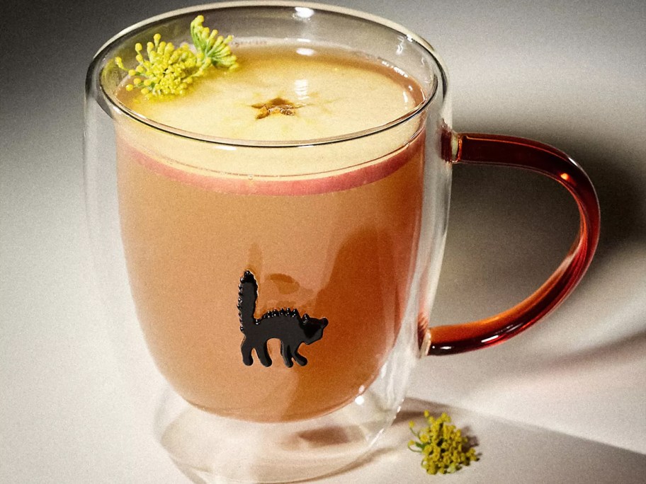 cat mug with drink on table