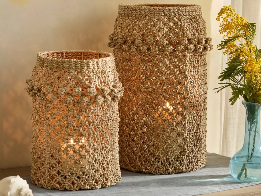 two macrame lanterns on table
