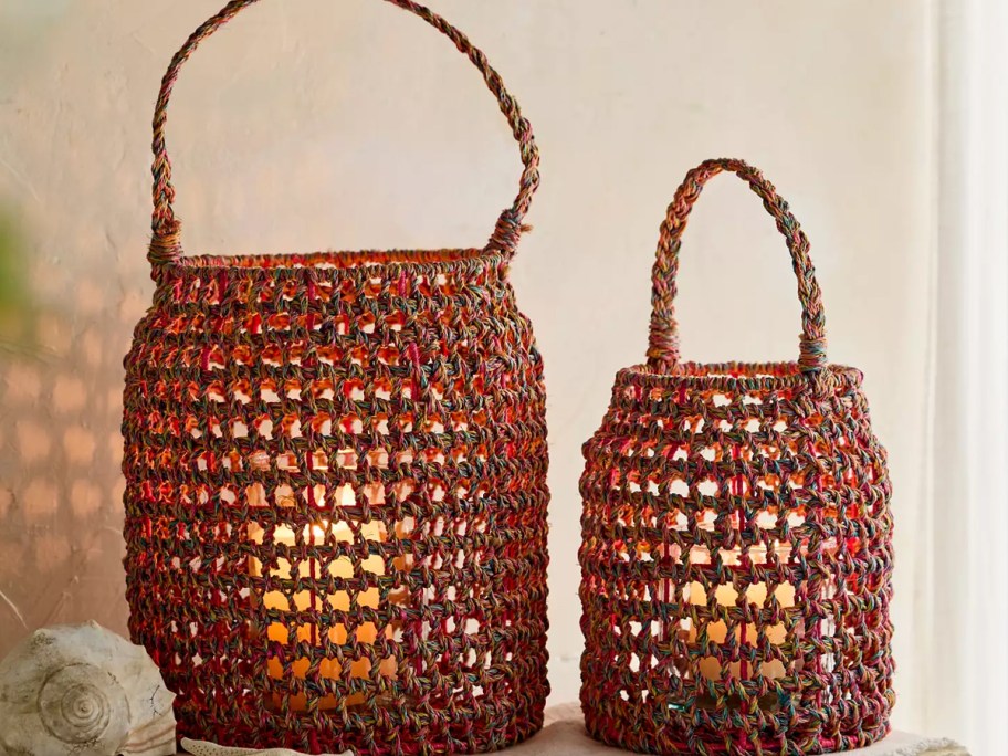 two red macrame lanterns on table