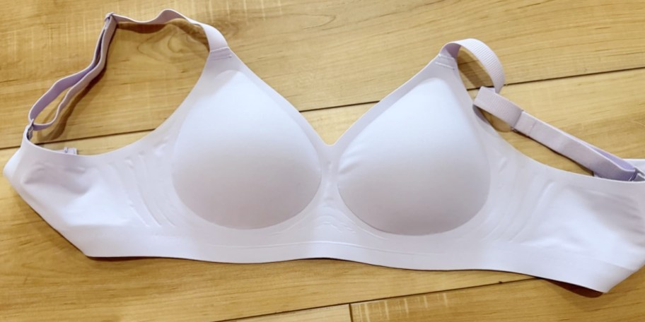 white bra laying on wood floor