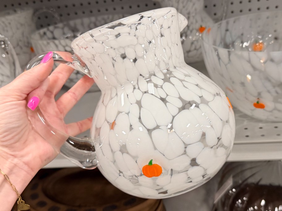 hand holding white pumpkin pitcher 