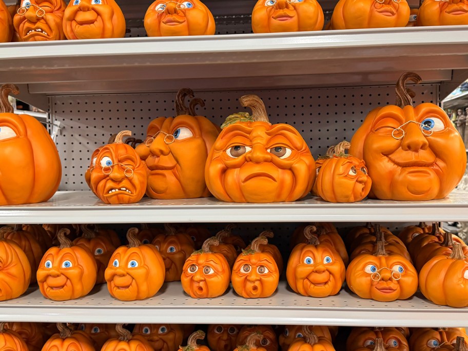 character faced pumpkins on shelf 