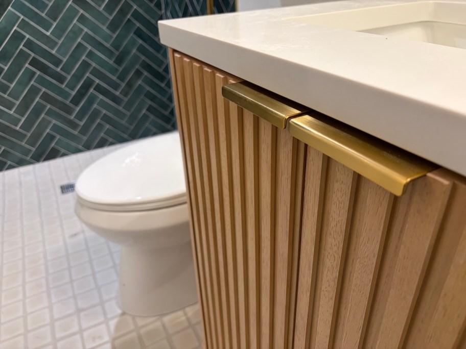 close up of wood and gold vanity