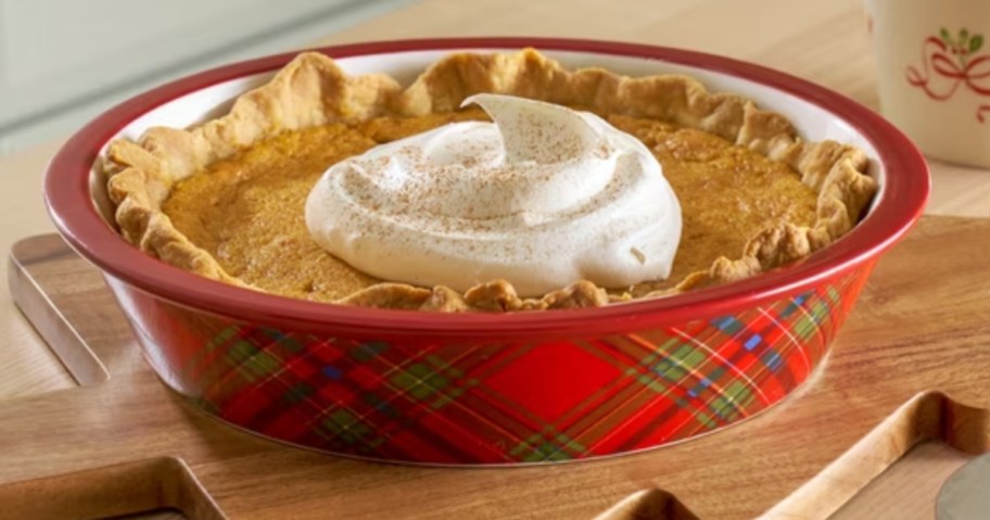a red and green plaid stoneware pie dish with a pumpkin pie in it