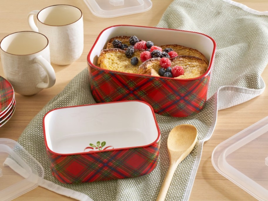 two red and green plaid stoneware serving dishes with lids