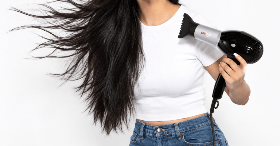 woman blowdrying her hair
