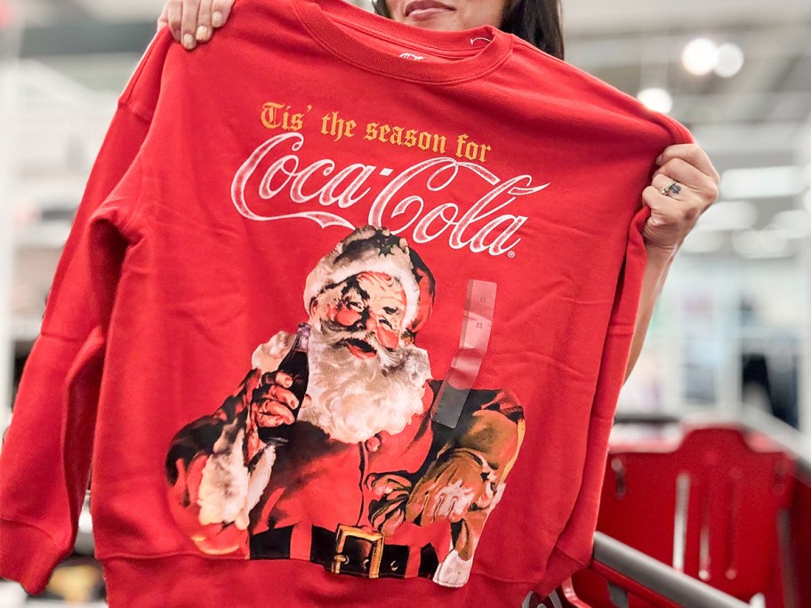 hand holding coca-cola sweatshirt