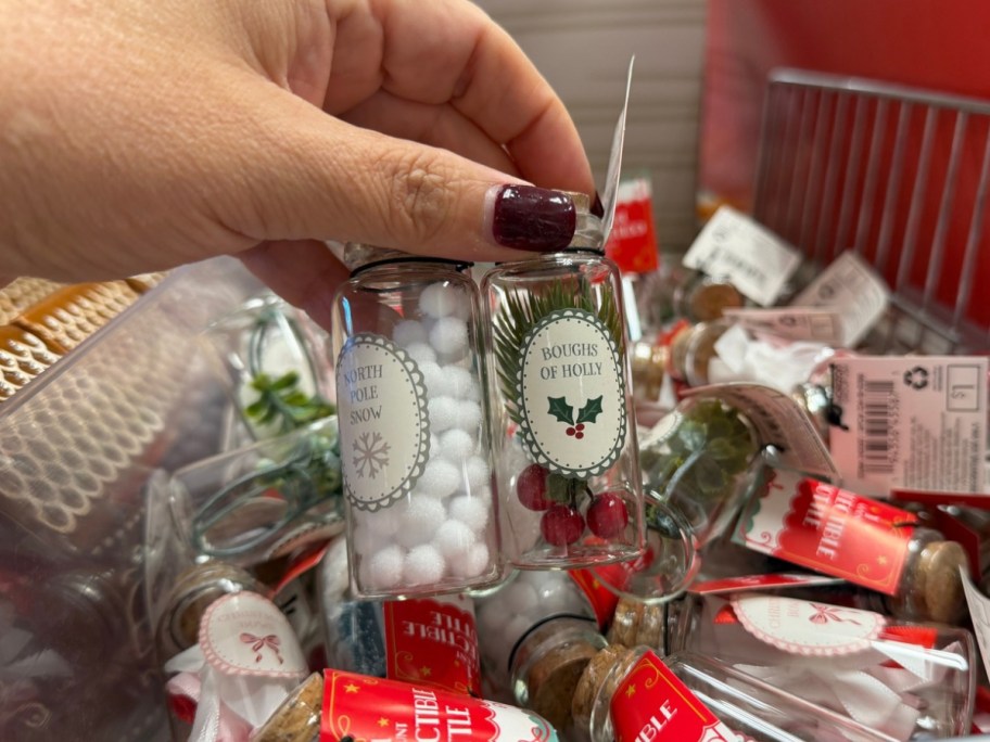 hand holding collectible bottles