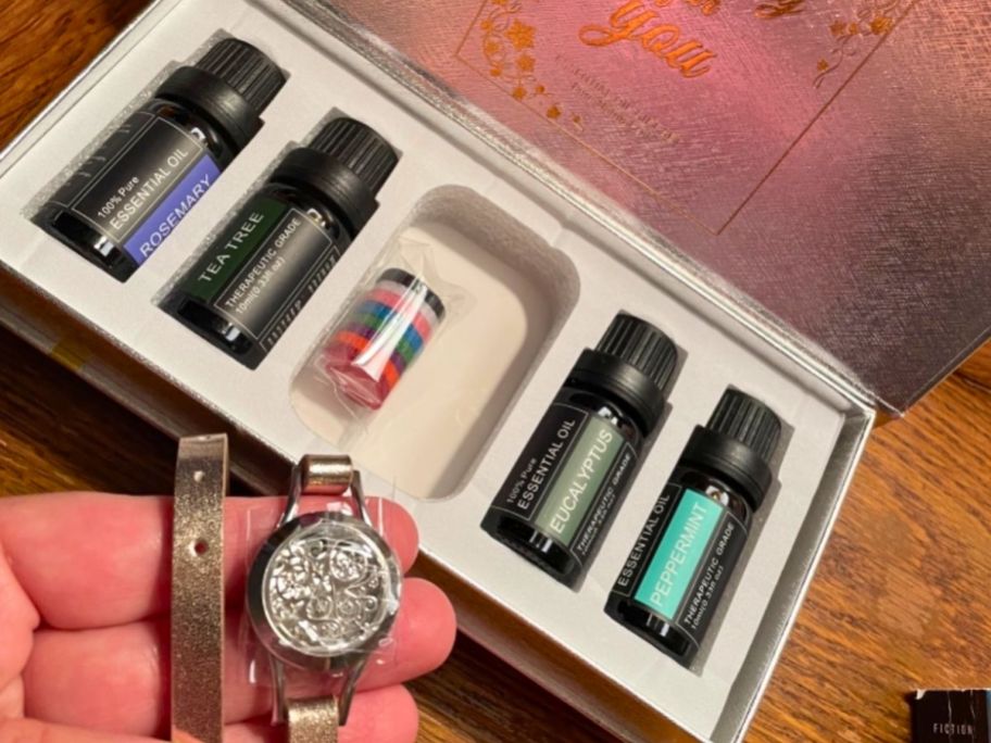 diffuser bracelet and scent in womans hand