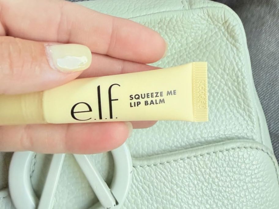 hand holding e.l.f. Squeeze Me Lip Balm