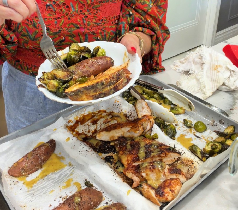 eating a plate of sheet pan roasted veggies and chicken 
