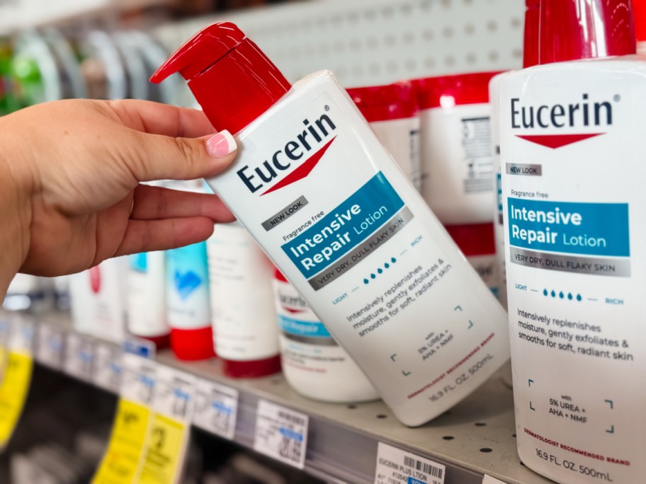 hand tipping a bottle of eucerin lotion off a store shelf