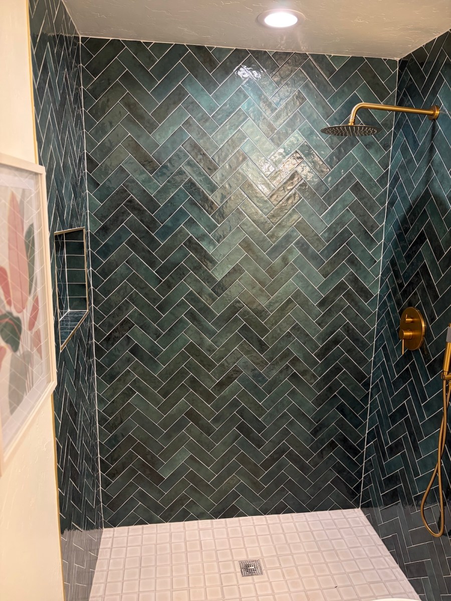 green herringbone shower tile