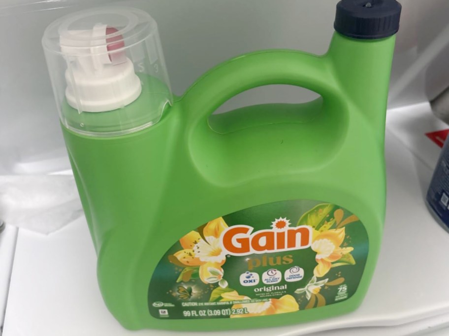 green laundry detergent bottle on washer