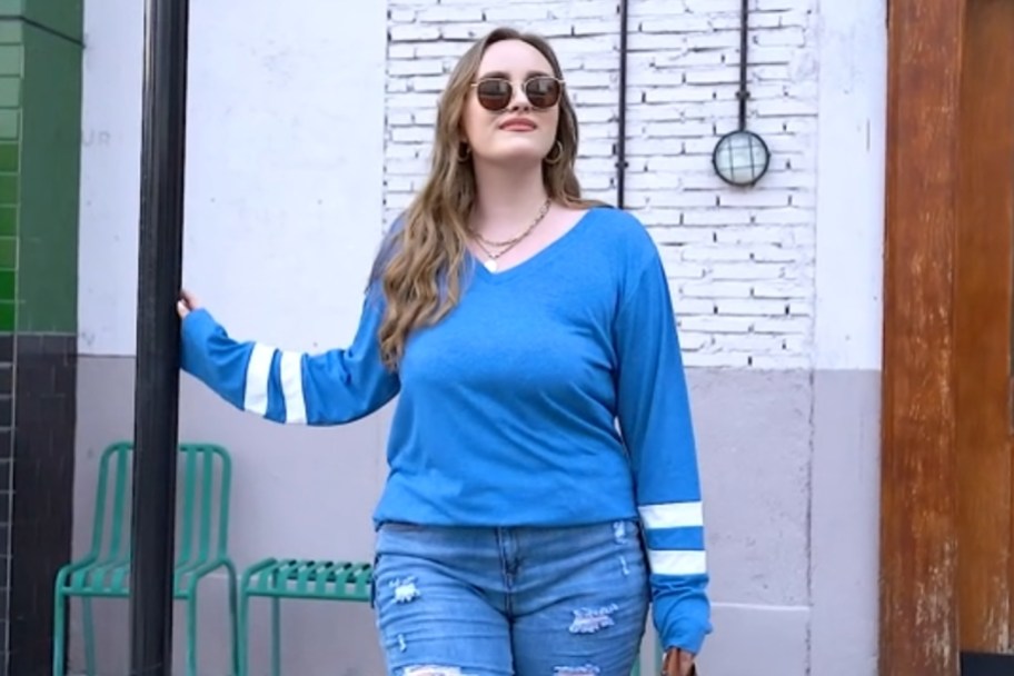woman wearing blue shirt next to light pole