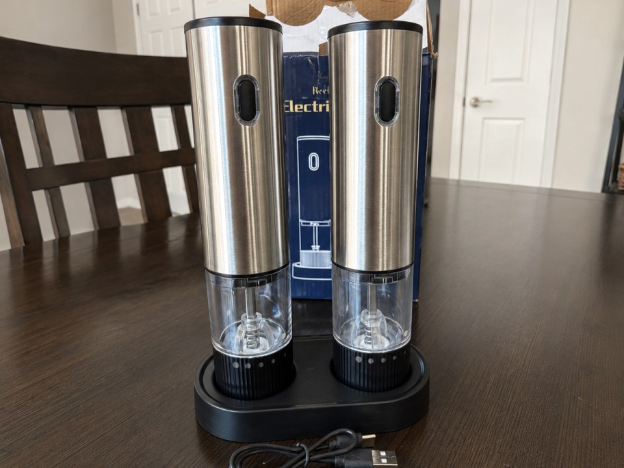 stainless steel salt & pepper grinders on kitchen table