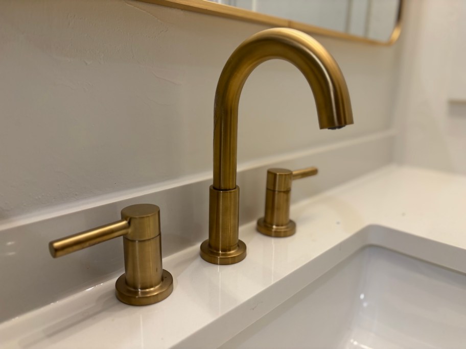 close up of gold bathroom faucet
