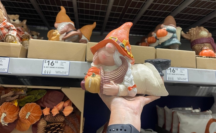 womans hand holding a harvest gnome