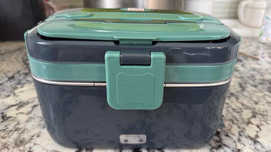 heated lunchbox in gray and green on top of the table