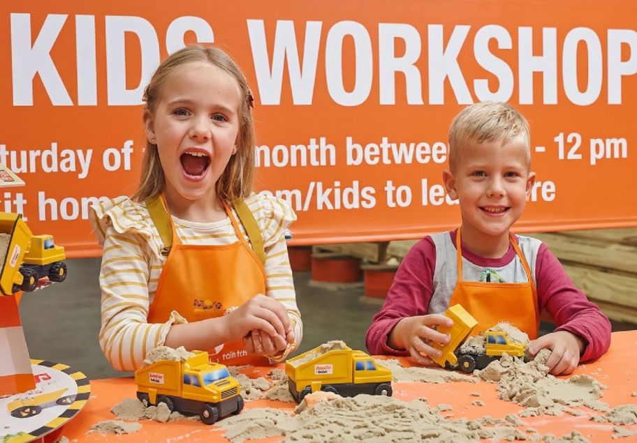 2 kids building trucks at a Home Depot workshop