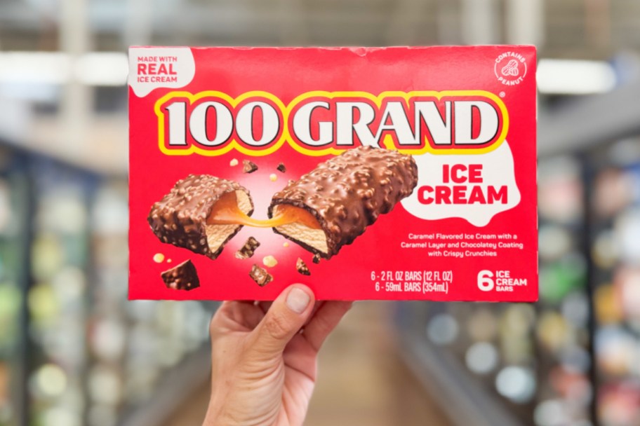 hand holding red ice cream candy bar box in aisle