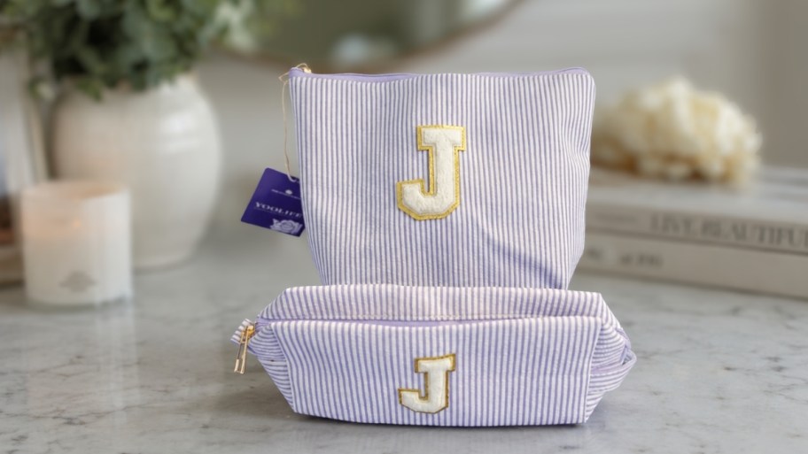initial makeup bag set on a countertop