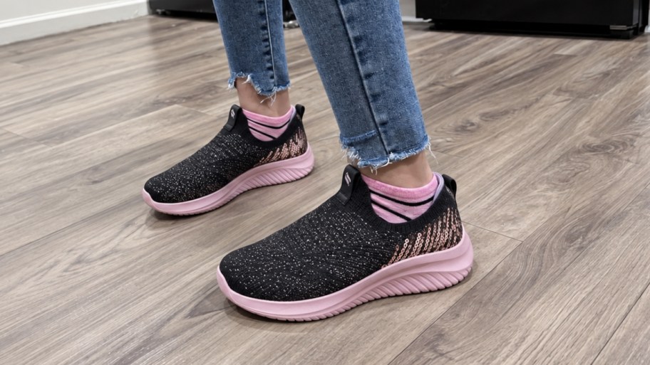 a kids feet wearing skechers sneakers