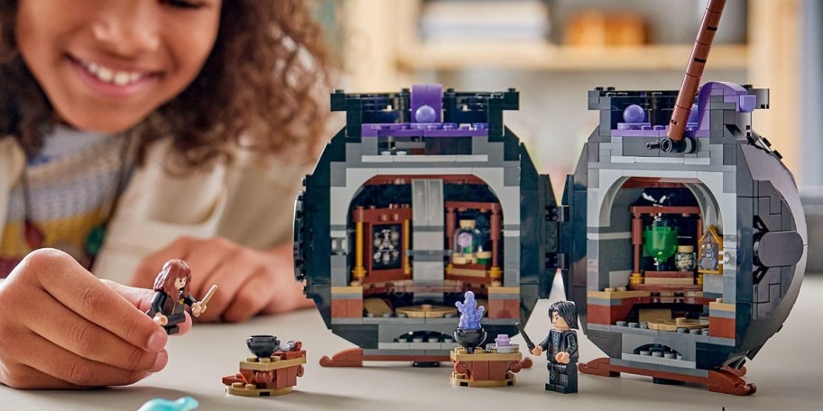 kid playing with lego harry potter cauldron set 