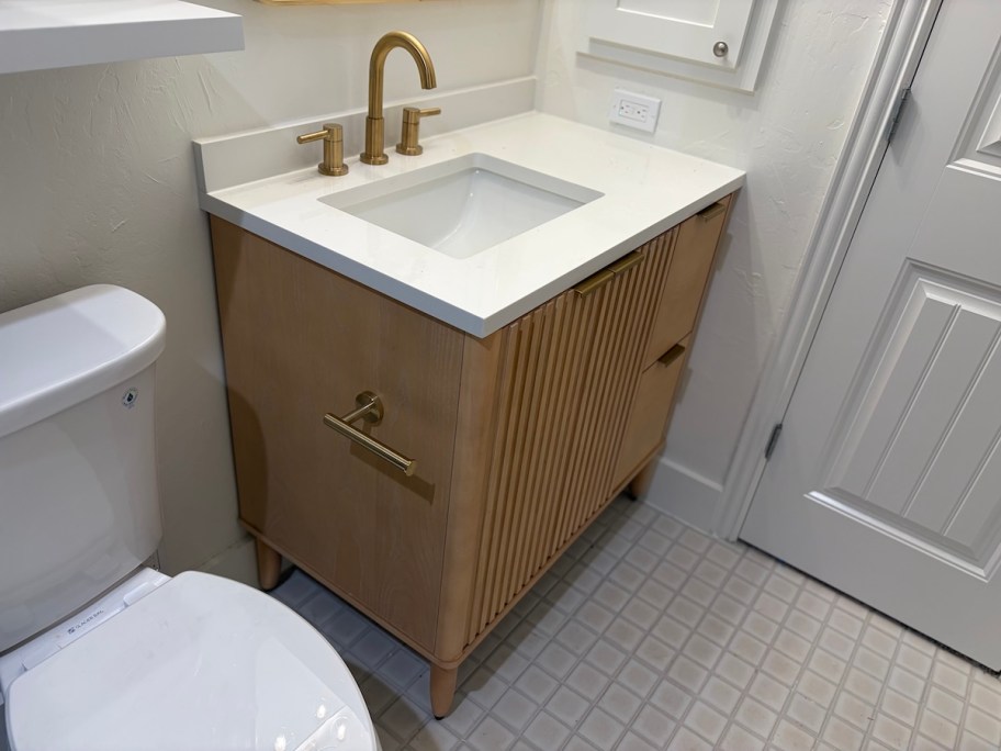 bathroom vanity with gold faucet