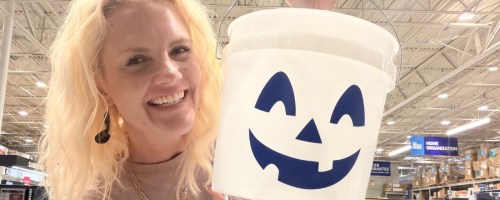 woman holding a white and blue halloween bucket