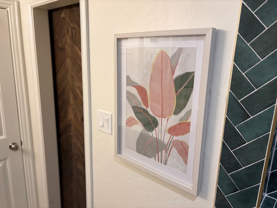 close up of framed palm leaves artwork 