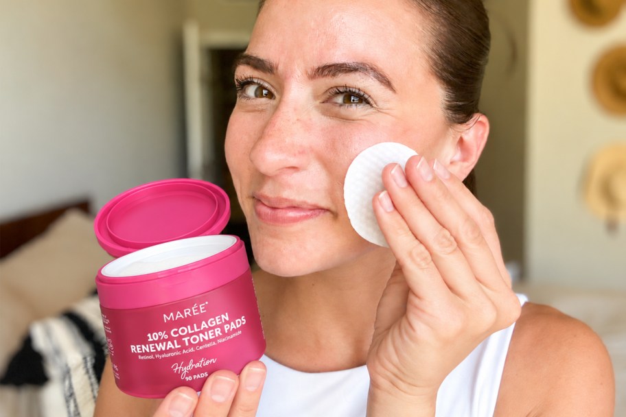 woman using a toner pad on her face