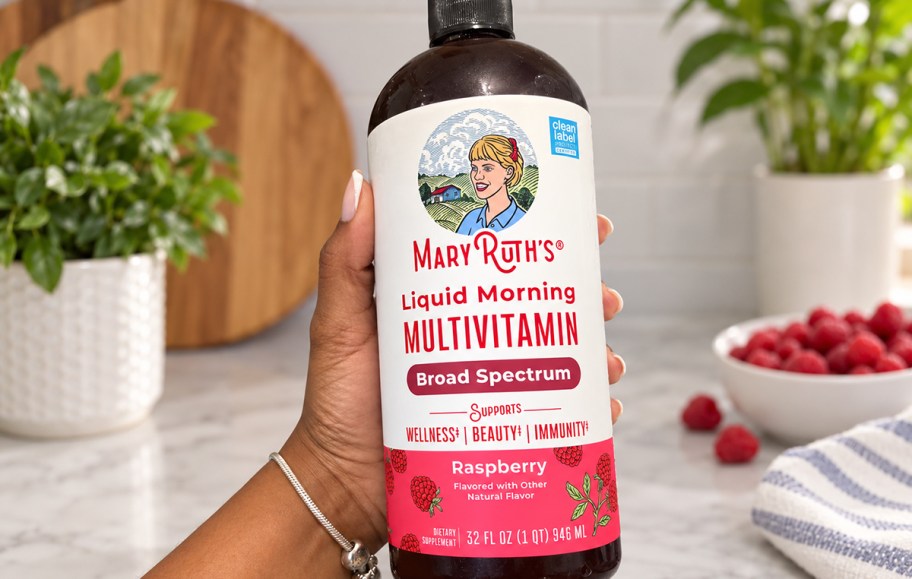 person holding bottle of mary ruth's liquid multivitamin