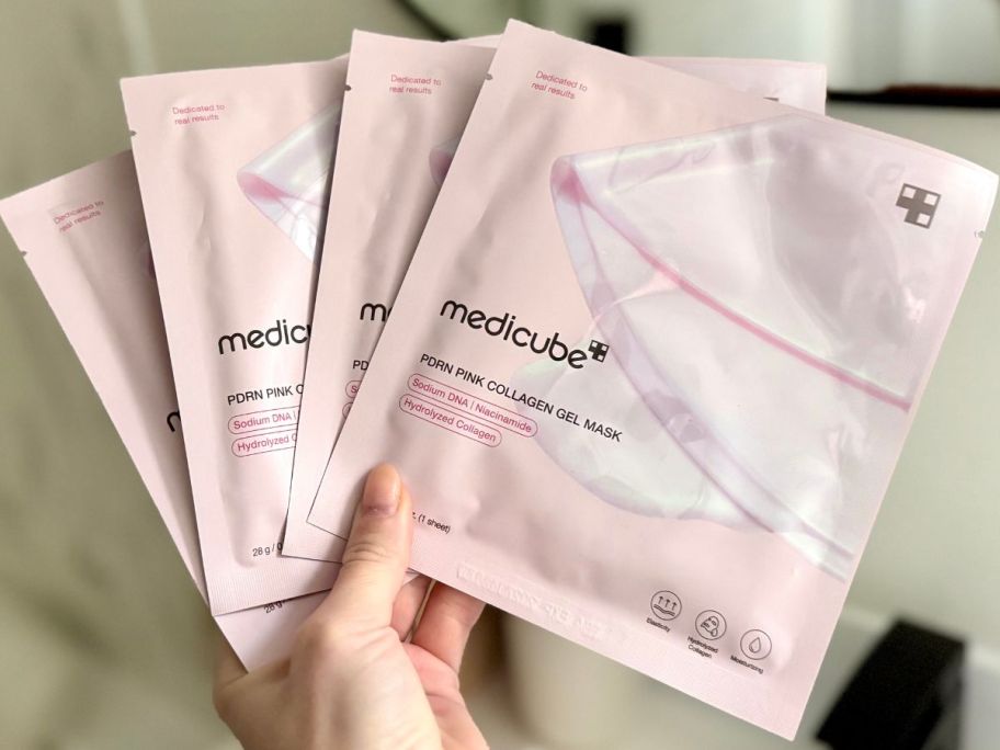 han holding a medicube Jelly Gel Mask w/ Salmon DNA PDRN Pink Collagen 4-pack