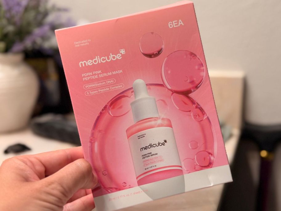 hand holding a medicube mask