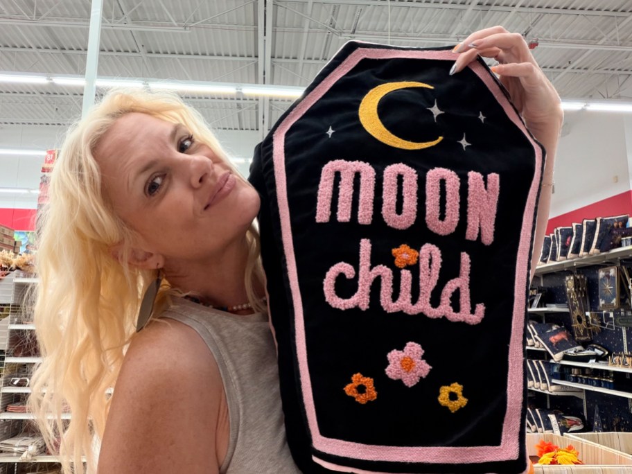 woman holding moon child coffin pillow