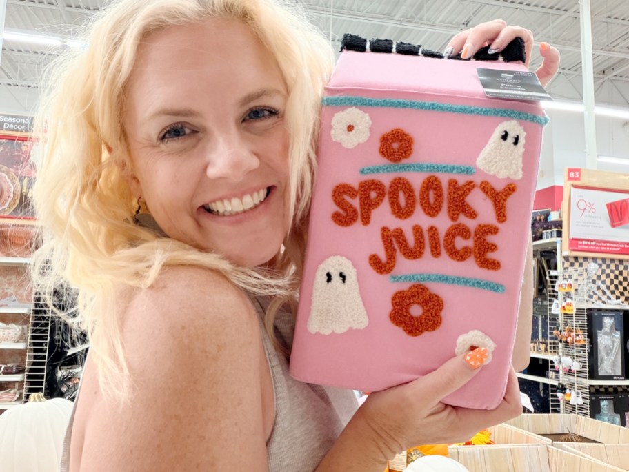 woman holding spooky juice pillow