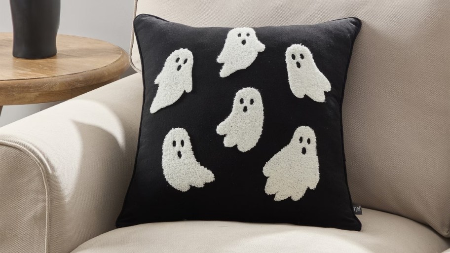 square black pillow with ghost motif on a chair