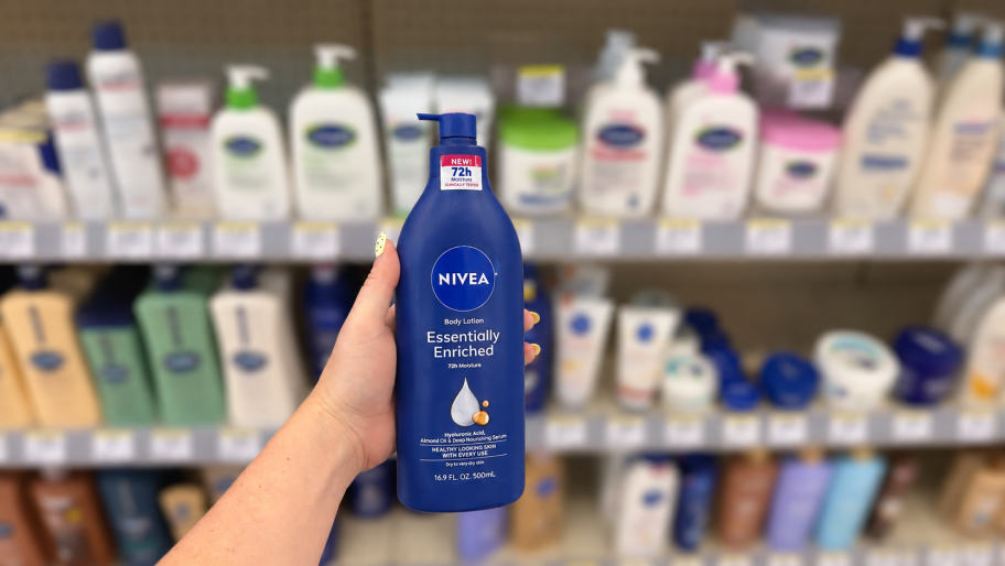 hand holding a bottle of body lotion in front of a store shelf