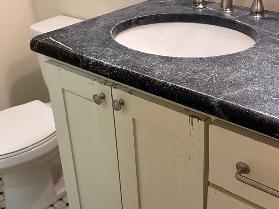 close up of bathroom vanity with chipped paint