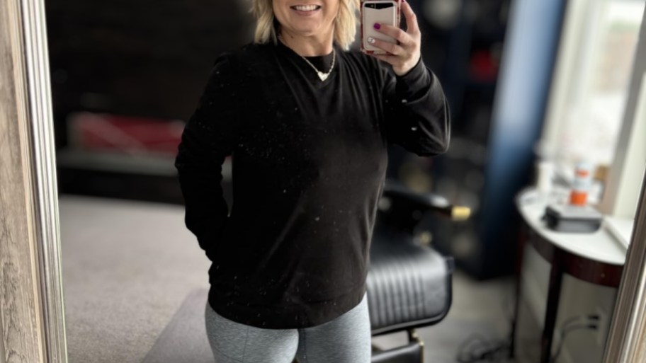 woman in a sweatshirt taking a selfie