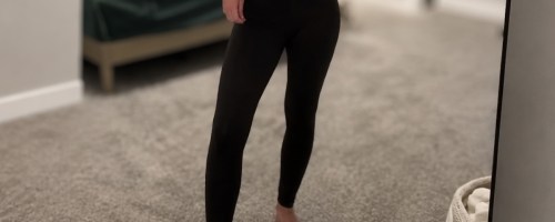 a woman taking a selfie and wearing a pair of leggings