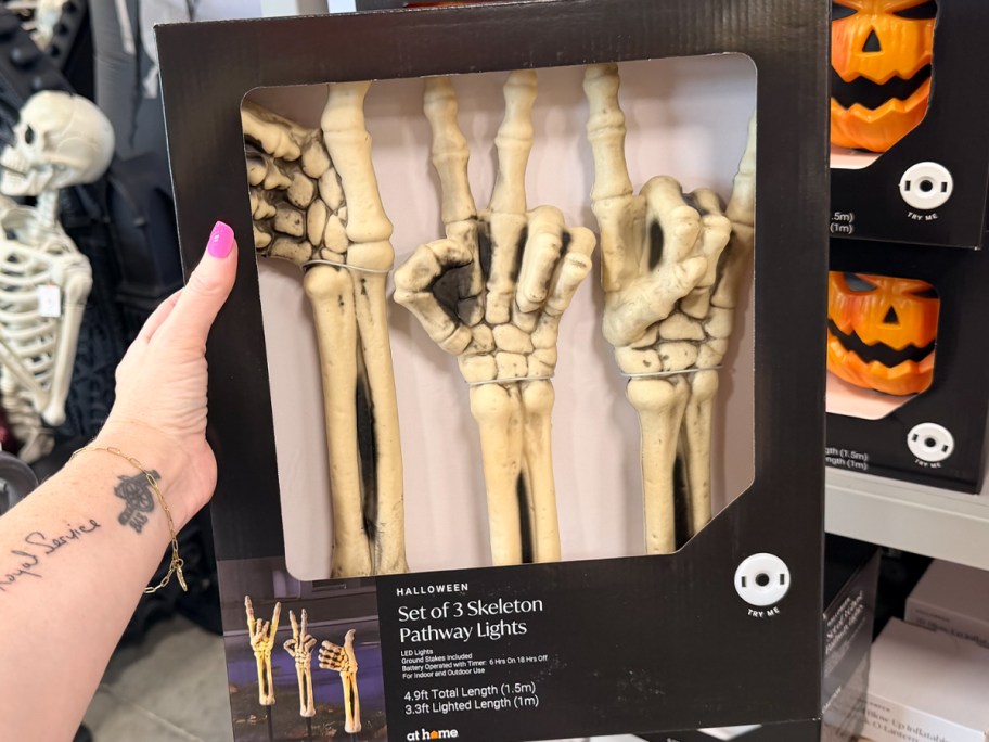 hand holding skeleton pathway lights 