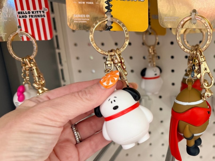 womans hand holding a snoopy