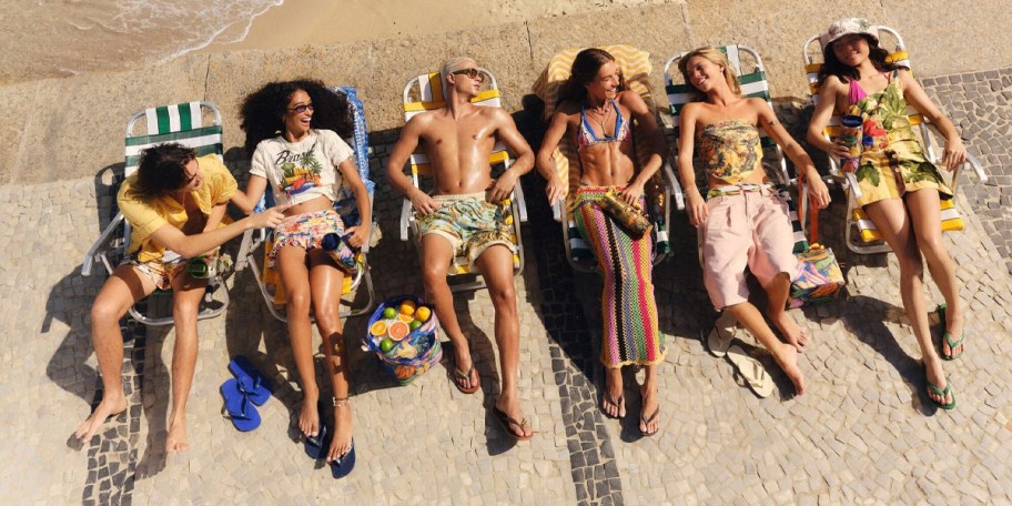 people sitting on beach in chairs 