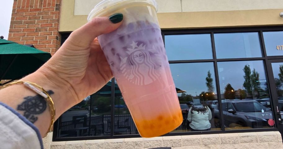 hand holding starbucks drink with popping pearls in it